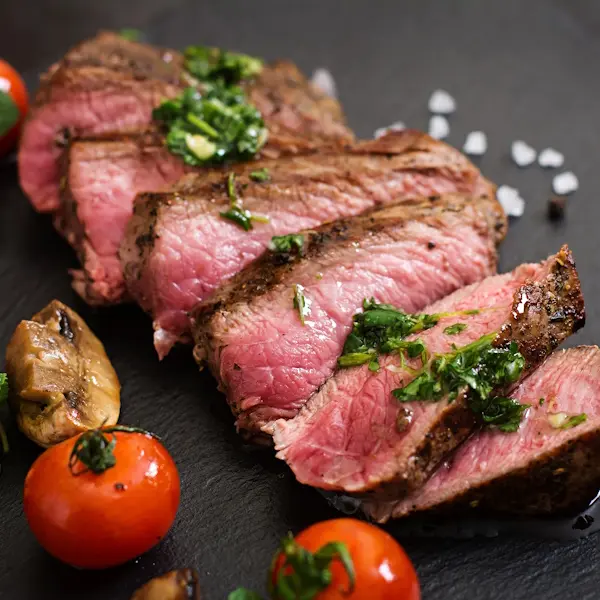 Juicy steak medium rare beef with spices and grilled vegetables.
