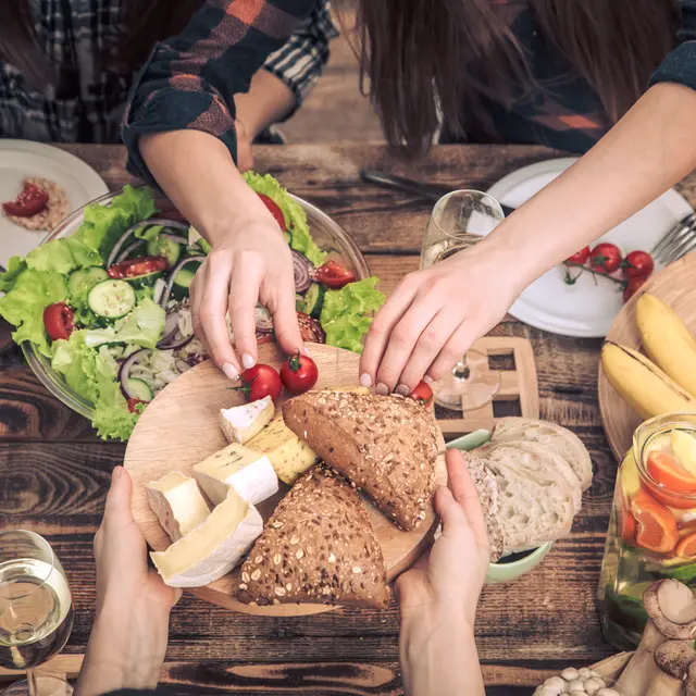 Enjoying dinner with friends. Top view of group of people having dinner together