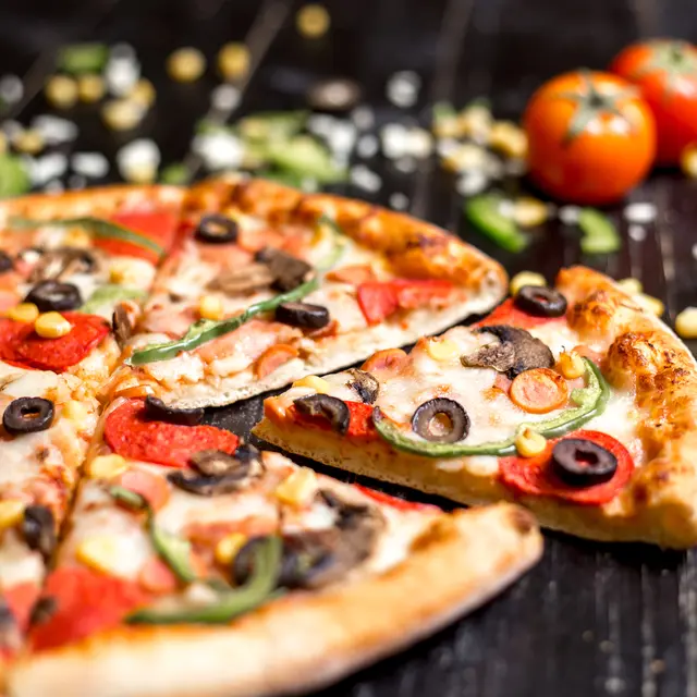 close up of pepperoni pizza slices with sausages mushroom olive bell pepper and cheese