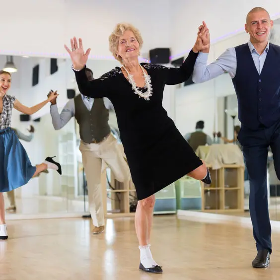 Mature woman dancing swing with young man