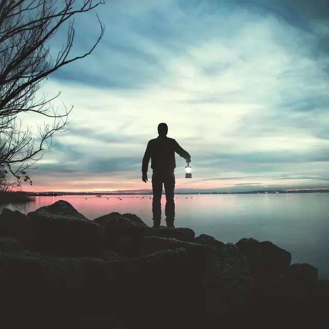 Man walking in the dark with a torch