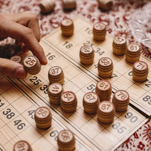 loto game man puts number tea side view