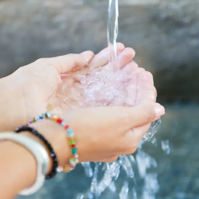 Woman's hands with water splash.
