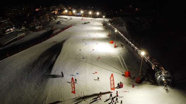 Winter Magic: Night Skiing on a Floodlit Slope