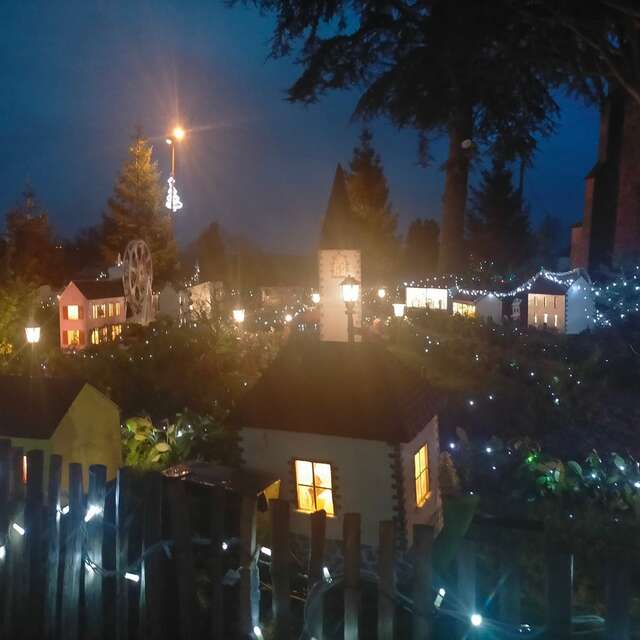 Village miniature illuminé, marché de Noël et concert