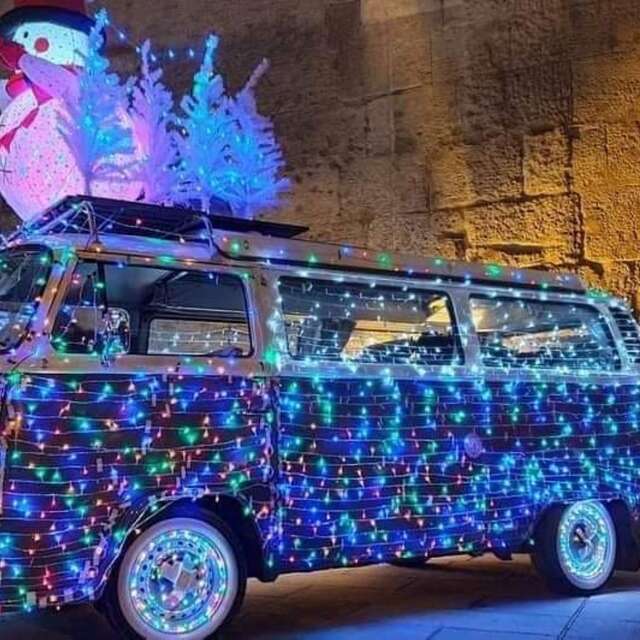 Parade of illuminated vintage cars