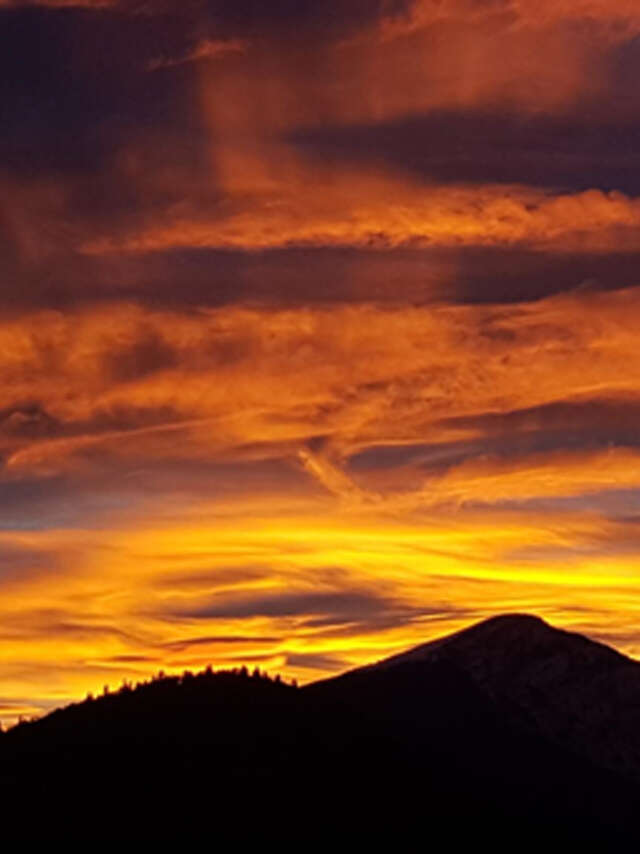 Contempler le coucher de soleil en raquettes à neige